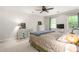 Bright bedroom featuring neutral walls, ceiling fan, and large windows for a cozy and airy feel at 1207 Candlewood Dr, Elon, NC 27244