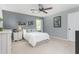 Bedroom with white bedspread, ceiling fan, and neutral walls at 1207 Candlewood Dr, Elon, NC 27244