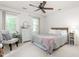 Bright bedroom with a ceiling fan, two windows, and neutral decor for a serene atmosphere at 1207 Candlewood Dr, Elon, NC 27244