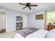Comfortable bedroom featuring a ceiling fan, a zebra painting, and a window providing natural light at 1207 Candlewood Dr, Elon, NC 27244