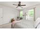Bright bedroom features neutral walls, fan, and two windows at 1207 Candlewood Dr, Elon, NC 27244