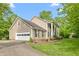 A lovely two-story home featuring an attached garage, vinyl siding and beautifully landscaped surroundings at 1207 Candlewood Dr, Elon, NC 27244