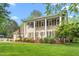 Inviting two-story home showcasing a well-manicured lawn, charming landscaping, and a classic colonial design at 1207 Candlewood Dr, Elon, NC 27244