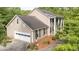 Traditional two-story home boasts a large two-car garage, manicured landscaping, and classic architectural details at 1207 Candlewood Dr, Elon, NC 27244