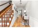 Welcoming foyer showcasing a wooden staircase, a console table, and an inviting view into the living room at 1207 Candlewood Dr, Elon, NC 27244