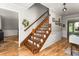 Traditional foyer featuring hardwood floors, classic staircase with wood railing, and neutral wall colors at 1207 Candlewood Dr, Elon, NC 27244