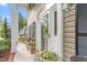 Inviting front porch with rocking chairs, planters, and a white door with glass panes for natural light at 1207 Candlewood Dr, Elon, NC 27244