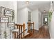 Bright hallway with hardwood floors and charming decorations leading to other rooms in the home at 1207 Candlewood Dr, Elon, NC 27244