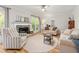 Cozy living room showcasing a stone fireplace, neutral furnishings, and a large window at 1207 Candlewood Dr, Elon, NC 27244