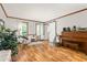 Bright living room with neutral colors, wood floors, large windows and a modern sliding barn door at 1207 Candlewood Dr, Elon, NC 27244
