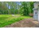 Exterior view featuring a rustic wooden deck and spacious grassy backyard perfect for outdoor activities at 1219 Junction Rd, Durham, NC 27704