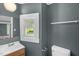 Bathroom featuring a vanity, mirror, toilet, and window at 1219 Junction Rd, Durham, NC 27704
