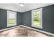 Bedroom featuring wood-look flooring and view of yard through window at 1219 Junction Rd, Durham, NC 27704