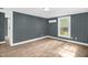 Inviting bedroom showcasing modern design with neutral wall color and beautiful wood-look floors at 1219 Junction Rd, Durham, NC 27704