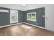 Bright bedroom featuring neutral walls, modern flooring, and views of the serene backyard scenery at 1219 Junction Rd, Durham, NC 27704