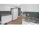 Bright kitchen featuring white cabinets and view of the living room at 1219 Junction Rd, Durham, NC 27704