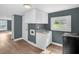 Kitchen featuring white cabinets and view of the front yard through window at 1219 Junction Rd, Durham, NC 27704