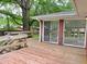 Spacious wooden deck leading to a brick home exterior with sliding glass doors at 122 E Orange St, Hillsborough, NC 27278