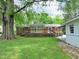 The backyard features a well maintained lawn, large tree, and patio at 122 E Orange St, Hillsborough, NC 27278