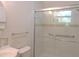 Updated bathroom featuring glass door shower and decorative tile accents at 122 E Orange St, Hillsborough, NC 27278