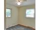 Carpeted bedroom with ample natural light from two large windows at 122 E Orange St, Hillsborough, NC 27278