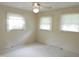 Bright bedroom featuring neutral carpet, ceiling fan, and natural light from the double window at 122 E Orange St, Hillsborough, NC 27278