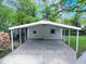 A well-maintained carport with a concrete slab, offering convenient covered parking and outdoor storage at 122 E Orange St, Hillsborough, NC 27278