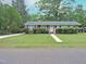Charming single-story home featuring a well-maintained lawn, brick accents, and a welcoming front entrance at 122 E Orange St, Hillsborough, NC 27278