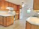 An expansive kitchen with tile flooring, and wooden cabinetry, offers a cozy cooking space at 122 E Orange St, Hillsborough, NC 27278