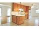 Charming kitchen features wooden cabinets, white appliances, and tile flooring at 122 E Orange St, Hillsborough, NC 27278