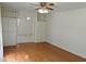 Bright living room showcasing wood floors, built-in cabinets, and an open doorway leading to additional space at 122 E Orange St, Hillsborough, NC 27278