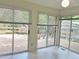 Bright sunroom with sliding glass doors leading to a wooden deck at 122 E Orange St, Hillsborough, NC 27278