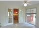 Tile-floored sunroom with kitchen view and backyard access through sliding doors at 122 E Orange St, Hillsborough, NC 27278