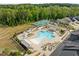 Aerial view of community pool, hot tub, and tennis courts on a sunny day at 140 Azure Mist Dr, Raleigh, NC 27610