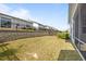 Well-maintained backyard with green grass, retaining wall, and black iron fence at 140 Azure Mist Dr, Raleigh, NC 27610