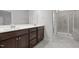 Bathroom features double sink vanity with dark wood cabinets and a tile shower at 140 Azure Mist Dr, Raleigh, NC 27610