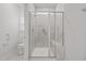 Bathroom with tiled shower featuring a glass door, seat, and hand assist bar at 140 Azure Mist Dr, Raleigh, NC 27610