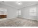Spacious bedroom with neutral carpet and tray ceiling features two windows and attached bath at 140 Azure Mist Dr, Raleigh, NC 27610