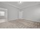 Bright bedroom with neutral carpet, white walls, and an open doorway at 140 Azure Mist Dr, Raleigh, NC 27610