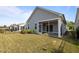 View of home's exterior with screened porch and well-maintained lawn at 140 Azure Mist Dr, Raleigh, NC 27610
