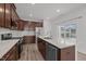 Elegant kitchen with a quartz island, stainless appliances, and easy access to the patio at 140 Azure Mist Dr, Raleigh, NC 27610