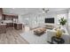 Open living room and kitchen with modern decor, ample natural light, and stainless steel appliances at 140 Azure Mist Dr, Raleigh, NC 27610
