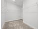 Large walk-in closet featuring wire shelving and neutral carpet at 140 Azure Mist Dr, Raleigh, NC 27610