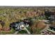 Expansive aerial view of estate nestled amidst a lush forest with a long private drive at 1416 Bailey Hill Dr, Raleigh, NC 27614