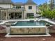 Beautiful backyard featuring a pool, spa, fire bowls, and a covered patio at 1416 Bailey Hill Dr, Raleigh, NC 27614