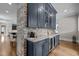 Stylish bar area with custom cabinetry, quartz countertops, and built-in beverage coolers at 1416 Bailey Hill Dr, Raleigh, NC 27614