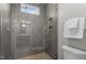 Modern bathroom shower with glass enclosure, gray tile, and sleek fixtures at 1416 Bailey Hill Dr, Raleigh, NC 27614