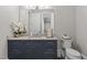 Bathroom featuring a vanity with granite countertop, modern fixtures and a large decorative mirror at 1416 Bailey Hill Dr, Raleigh, NC 27614