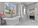 A spa-like bathroom features a soaking tub next to a large window at 1416 Bailey Hill Dr, Raleigh, NC 27614