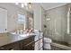 Bathroom featuring double sinks and a glass-enclosed shower with modern fixtures at 1416 Bailey Hill Dr, Raleigh, NC 27614
